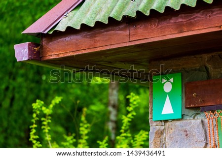 Public Restroom. White Female symbol on green background on Toilet Sign
