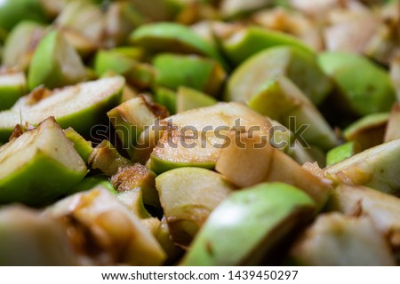 Ripe green apples sliced ​​into slices, close-up with the effect of dof, healthy food for all ages
