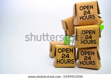 Open 24 Hours Text in small boxes and shopping cart. Concepts about online shopping. Isolated on white background