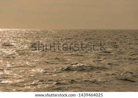 Beautiful sunrise or sunset sky on the beach. Sunset sky into the sea with wave, horizon, blue and gold sky. high-quality stock photo image of beauty landscape with sunrise over sea in nature