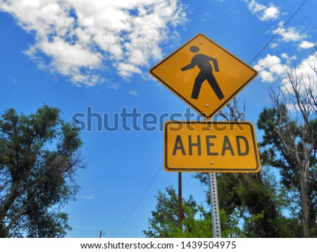 pedestrians are crossing ahead sign