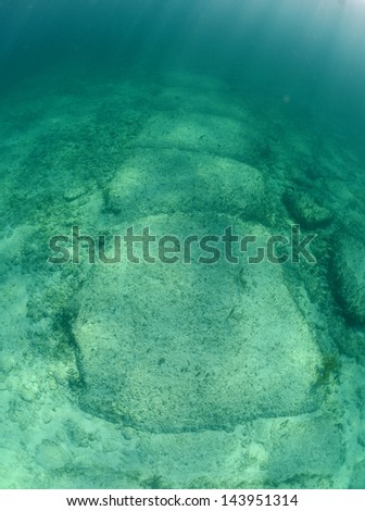 Underwater rock formation in the Bahamas named Bimini Road that is thought by some to be remnants of Atlantis Royalty-Free Stock Photo #143951314
