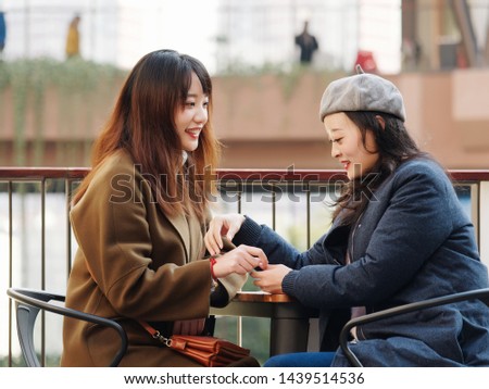 Cute positive portrait of best friend pretty young girls, natural glowing makeup, Two young hipster girl sisters sit together chit chat outdoor and having fun together.