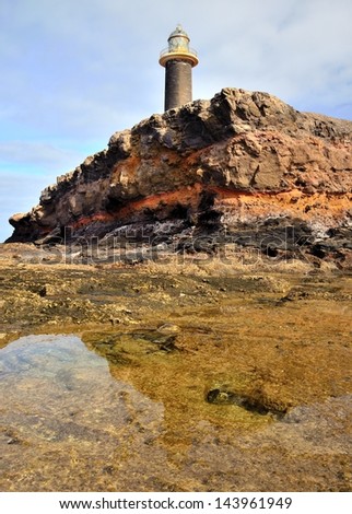 Water reflections on puddles in the reef, lighthouse tip of Jandia,coast of Fuerteventura, Canary islands, Spain