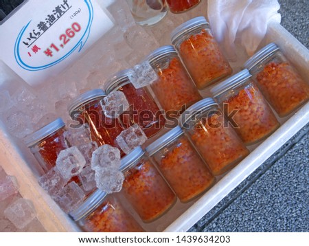 Glass Cans of Ikura red salmon caviar for sale on famous Sapporo Nijo fish Market 
