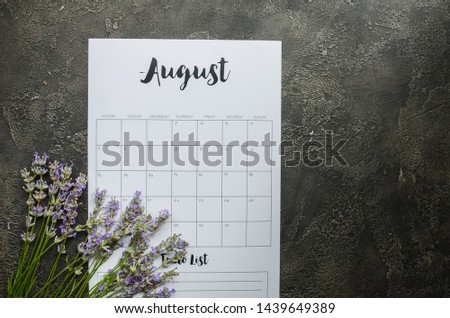 calendar with  and lavender flowers on gray background. August 2019. Concept stylish workplace Flat lay Top view 