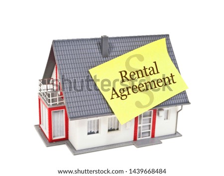 House with yellow sticker and rental agreement isolated