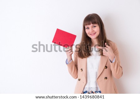 Portrait of a foreign woman in front of a white wall