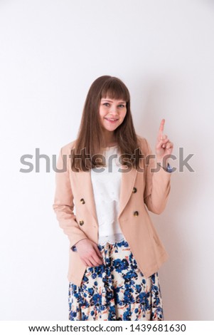 Portrait of a foreign woman in front of a white wall