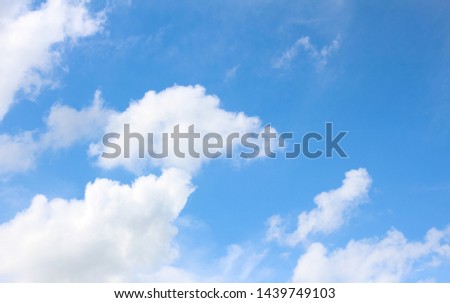 White clouds and blue sky background.