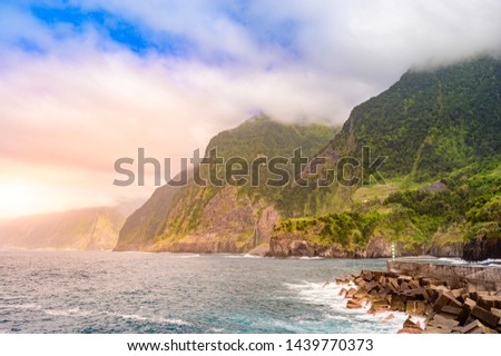 Beautiful wild coast scenery view with Bridal Veil Falls (Veu da noiva) at Ponta do Poiso in Madeira Island. Near Porto Moniz, View from Seixal, Portugal.