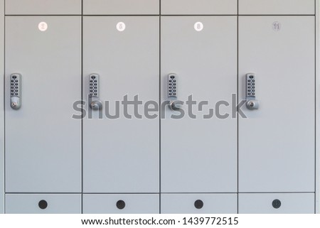 White change room lockers with electronic access control in a public room like the wardrobe in a changing room.