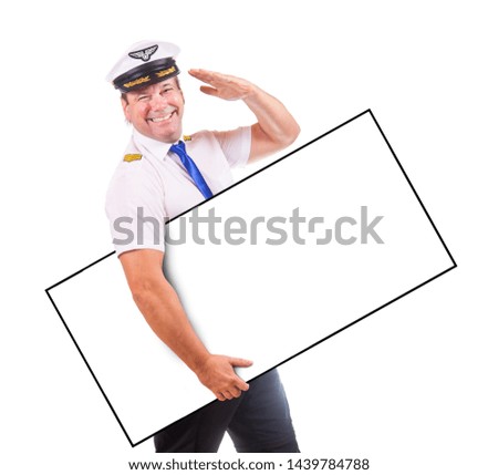 A cheerful pilot hold emty panel and salute with his hand, isolated on white background. Captain of air plane with board.