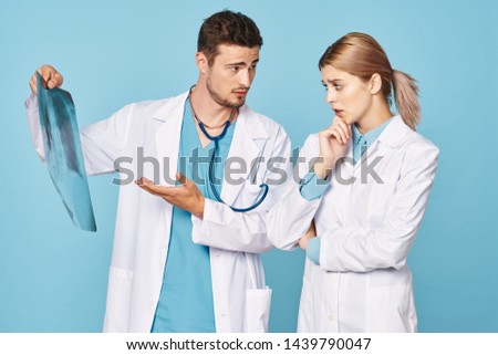 Male and female doctor x-ray picture of work colleague patient study