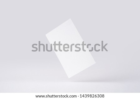 Design concept - front view of surreal white business card float on mid air isolated on white background for mockup, it's real photo, not 3D render