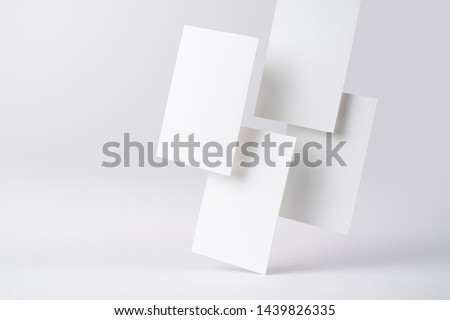 Design concept - front view of 4 surreal white business card float on mid air isolated on white background for mockup, it's real photo, not 3D render