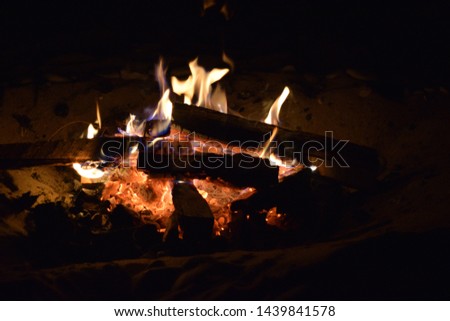Close up of a fire on the beach. Camping trip
