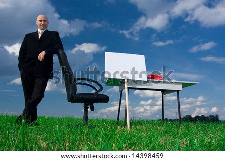 Business man leaning on a chair in an outdoor office.  Blank sign for copy.Available space for text.