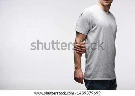cropped view of man holding hand behind back isolated on grey, human emotion and expression concept Royalty-Free Stock Photo #1439879699