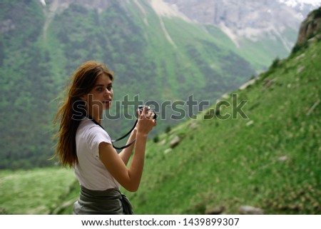 woman looking into camera nature mountain view