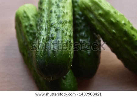 cucumbers lie on a wooden table cut and whole