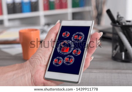Female hand holding a smartphone with spam concept