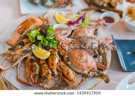 Picture of A delicious seafood at luxury restaurant. A plate of fresh seafood with shrimps, prawns, crabs, salmon, squid and mussels