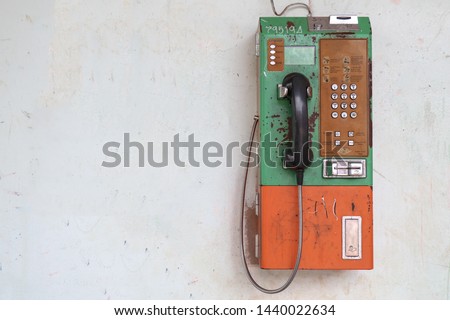 old public telephone on the wall, Vintage public telephone Royalty-Free Stock Photo #1440022634