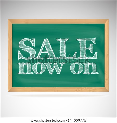 Sale now on - the inscription chalk on the green chalkboard in a wooden frame