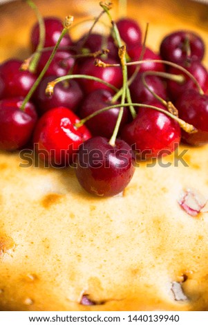 Traditional homemade cheesecake with cherries on the wooden table. Selective focus. Shallow depth of field.