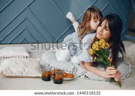 Child give mother flowers. Family at home. Mother's day