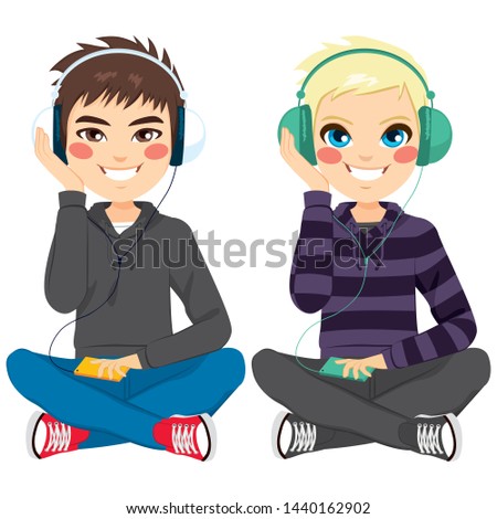 Young boys on casual clothes sitting on floor listening to music with headphones