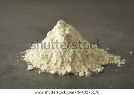 Pile or heap of rice flour isolated ondark background. Gluten free flour. Healthy food. Isolated.