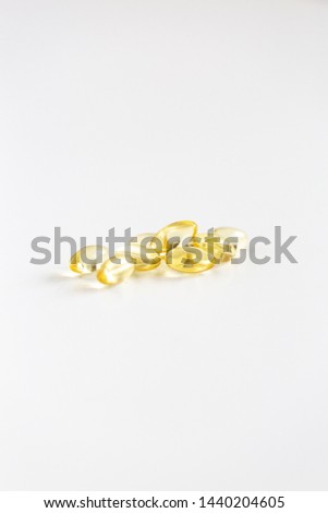 Group of Yellow Pills on White Background, CBD Capsules, Vitamins