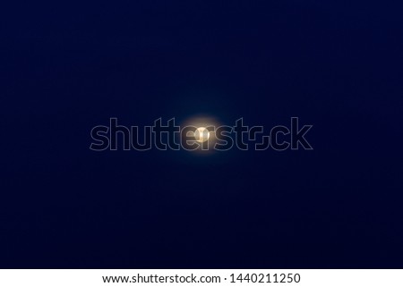 Full moon in the night blue sky