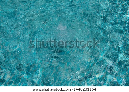 Bubble fountain in the swimming pool clean and clear water beautiful blue tiles - image