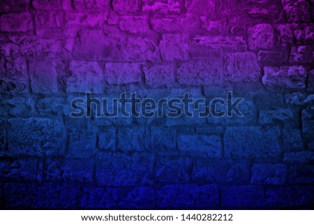 Neon colored limestone brick wall background. Horizontal toned and vignetted backdrop
