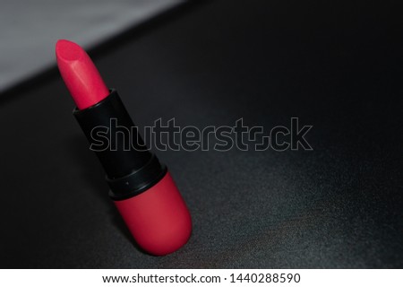 red lipstick on the black table