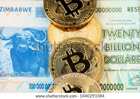 Bitcoin Cryptocurrency coins on Zimbabwe hyperinflation banknote. Cryptocurrency Bitcoin coins with Zimbabwe money. Africa Zimbabwe Bitcoin BTC Cryptocurrency Dollar