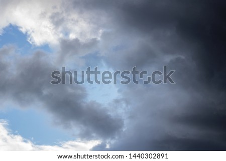Black clouds in the blue sky, background