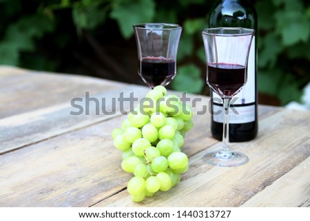 Valentine's Day drink of red wine in glass with grapes on a table no people stock photo