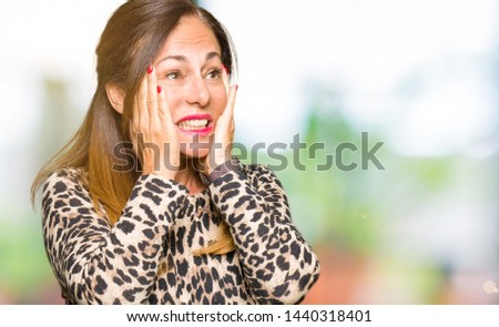 Beautiful middle age woman wearing leopard animal print dress Tired hands covering face, depression and sadness, upset and irritated for problem