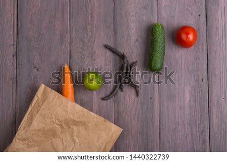 Healthy vegetarian food concept - paper eco bag with various vegetables on wooden table