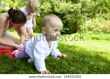 baby with a family in the park