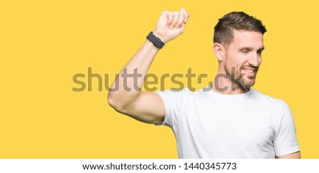 Handsome man wearing casual white t-shirt Dancing happy and cheerful, smiling moving casual and confident listening to music