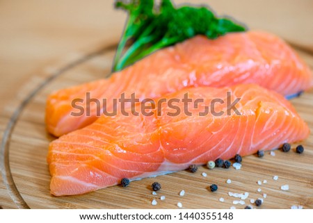 Raw salmon steak on wooden background