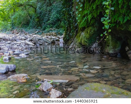 Mountain stream flowing along the stone rocks.