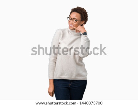 Young beautiful african american woman wearing glasses over isolated background smiling doing phone gesture with hand and fingers like talking on the telephone. Communicating concepts.