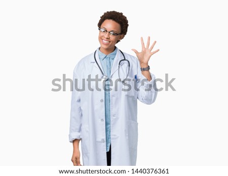 Young african american doctor woman wearing medical coat over isolated background showing and pointing up with fingers number five while smiling confident and happy.