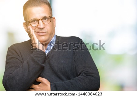 Middle age bussines arab man wearing glasses over isolated background thinking looking tired and bored with depression problems with crossed arms.